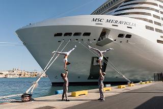MSC cruise ship sailing across the open ocean under a clear blue sky.